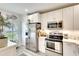 Modern kitchen with stainless steel appliances, white cabinets, and stylish finishes at 4727 Sabal Key Dr # 4727, Bradenton, FL 34203
