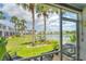 Scenic screened-in patio view of lush greenery, a calm lake, and neighboring properties at 4727 Sabal Key Dr # 4727, Bradenton, FL 34203