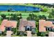 Aerial view of luxury homes featuring tile roofs, lush landscaping, and tranquil lake views at 4809 Benito Ct, Bradenton, FL 34211
