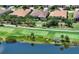 Aerial view of home with pool, golf course frontage, and lake view at 4809 Benito Ct, Bradenton, FL 34211