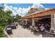 Outdoor bar with patio seating, orange umbrellas, and a lively social atmosphere at 4809 Benito Ct, Bradenton, FL 34211