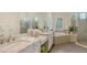 Elegant bathroom features dual sinks, granite countertops, a soaking tub, and a walk-in shower at 4809 Benito Ct, Bradenton, FL 34211