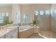 A clean bathroom features a soaking tub, walk-in shower, and bright lighting at 4809 Benito Ct, Bradenton, FL 34211