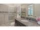 Bathroom featuring granite countertops, a walk-in shower, and sleek fixtures at 4809 Benito Ct, Bradenton, FL 34211