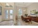 Formal dining room with elegant decor, modern lighting, and beautiful French door entry with intricate leaded glass at 4809 Benito Ct, Bradenton, FL 34211