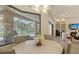 Bright dining room with a view of the lanai, outdoor pool, and living room with a fireplace at 4809 Benito Ct, Bradenton, FL 34211