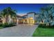 Beautiful home with a three-car garage and paved driveway, framed by manicured lawn and tropical landscaping at 4809 Benito Ct, Bradenton, FL 34211