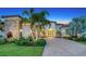 Stunning exterior view of home with lush landscaping, stone accents, and arched entryway at twilight at 4809 Benito Ct, Bradenton, FL 34211