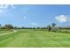 Expansive view of the lush golf course with clear blue skies and manicured greens at 4809 Benito Ct, Bradenton, FL 34211
