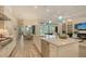 The spacious eat-in kitchen features an island, stainless steel appliances, tile flooring, and an open floor plan at 4809 Benito Ct, Bradenton, FL 34211