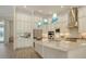A gourmet kitchen features an island with white cabinets, stainless steel appliances and granite countertops at 4809 Benito Ct, Bradenton, FL 34211