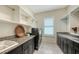 Well-organized laundry room with granite countertop, cabinets, and modern washer and dryer at 4809 Benito Ct, Bradenton, FL 34211