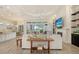 Open-concept living room featuring tile floors, tray ceiling, fireplace, and views of the outdoor living area at 4809 Benito Ct, Bradenton, FL 34211