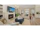 Inviting living room with fireplace, shelving, and comfortable seating; seamlessly connects to the dining area at 4809 Benito Ct, Bradenton, FL 34211