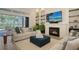 Inviting living room with fireplace, backyard views, and stylish decor creates a cozy atmosphere at 4809 Benito Ct, Bradenton, FL 34211