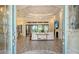Bright living room featuring tile floors, a fireplace, tray ceilings, and sliding glass doors at 4809 Benito Ct, Bradenton, FL 34211