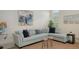 The living room has light blue sofas, decorative pillows, wood-look tile flooring, and neutral walls at 4809 Benito Ct, Bradenton, FL 34211