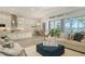 Open-concept living space with modern kitchen, dining area, and comfortable seating near expansive windows at 4809 Benito Ct, Bradenton, FL 34211