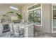 Built-in outdoor kitchen with stainless steel grill, mini fridge, and bar seating for outdoor entertaining at 4809 Benito Ct, Bradenton, FL 34211