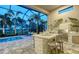 Outdoor living featuring a pool, lounge chairs, and a built-in bar with seating for outdoor entertaining at 4809 Benito Ct, Bradenton, FL 34211