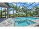 Inviting screened-in pool and spa area, surrounded by lush landscaping and serene views at 4809 Benito Ct, Bradenton, FL 34211