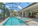 Stunning screened-in pool area with integrated spa and outdoor kitchen, perfect for entertaining at 4809 Benito Ct, Bradenton, FL 34211