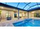 An impressive pool and hot tub are surrounded by outdoor furniture and a covered patio with an outdoor bar at 4809 Benito Ct, Bradenton, FL 34211