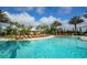 Inviting pool area with lounge chairs, palm trees, and clear blue water under a sunny sky at 4809 Benito Ct, Bradenton, FL 34211