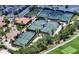 Aerial view of tennis courts with green surfaces, surrounded by lush landscaping at 4809 Benito Ct, Bradenton, FL 34211