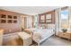 Bright bedroom with a queen bed, bench and large windows at 5046 Rocky Coast Pl, Palmetto, FL 34221