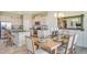 Kitchen and dining area featuring stainless steel appliances, granite countertops, and modern decor at 5116 Rosado Run, Lakewood Ranch, FL 34211