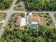 Aerial view features the screened pool, detached garage, oversized driveway and landscaping at 5266 Wagon Wheel Dr, North Port, FL 34291