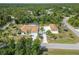 Expansive property features a screened pool, an oversized driveway, a separate garage, and lush tropical landscaping at 5266 Wagon Wheel Dr, North Port, FL 34291