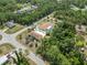 Aerial view of two homes in lushly landscaped neighborhood with mature trees and a shared screened pool at 5266 Wagon Wheel Dr, North Port, FL 34291
