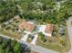 Aerial view of two homes in lushly landscaped neighborhood with mature trees and a shared screened pool at 5266 Wagon Wheel Dr, North Port, FL 34291
