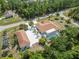 Aerial view of property showcasing a screened pool, a separate garage, extended driveway, and mature trees at 5266 Wagon Wheel Dr, North Port, FL 34291