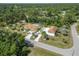 Aerial view of tropical property with screened pool, separate garage, extended driveway, and lush landscaping at 5266 Wagon Wheel Dr, North Port, FL 34291