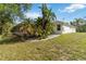 Well-maintained backyard with tropical landscaping and a screened-in pool enclosure at 5266 Wagon Wheel Dr, North Port, FL 34291
