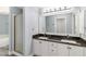 Bathroom featuring double sinks, granite countertops, and walk-in shower at 5266 Wagon Wheel Dr, North Port, FL 34291