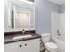 Clean bathroom showcasing a granite countertop vanity, toilet, and a shower-tub combination with white tile surround at 5266 Wagon Wheel Dr, North Port, FL 34291