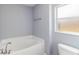 Bright bathroom with a soaking tub and frosted window at 5266 Wagon Wheel Dr, North Port, FL 34291
