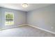 Comfortable bedroom featuring soft carpeting and natural light at 5266 Wagon Wheel Dr, North Port, FL 34291