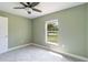 Bedroom featuring soft carpeting, ceiling fan, and exterior door at 5266 Wagon Wheel Dr, North Port, FL 34291