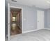 Spacious bedroom with plush carpeting, doorway view to the hallway, and a door that leads to the closet at 5266 Wagon Wheel Dr, North Port, FL 34291