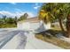 Garage exterior featuring white walls, dual roll-up doors and long driveway at 5266 Wagon Wheel Dr, North Port, FL 34291