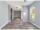 Hallway with arch doorway and view to a bright kitchen at 5266 Wagon Wheel Dr, North Port, FL 34291
