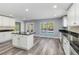 Bright kitchen with white cabinets and a view to the outdoor pool at 5266 Wagon Wheel Dr, North Port, FL 34291