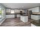 Open concept kitchen featuring stainless steel appliances, countertops, and wood flooring at 5266 Wagon Wheel Dr, North Port, FL 34291