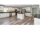 Modern kitchen with center island, granite counters, and stainless appliances at 5266 Wagon Wheel Dr, North Port, FL 34291