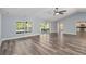 Bright open floor plan with new gray wood flooring, vaulted ceiling, recessed lighting, and views to the pool at 5266 Wagon Wheel Dr, North Port, FL 34291